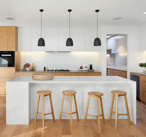 brown wooden seat beside white wooden table